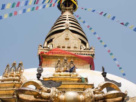 At the base of the Swayambhunath stupa with the Buddhist Vajra thunderbolt visible