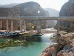 Dual carriageway slung across the entrance to Wadi Shab